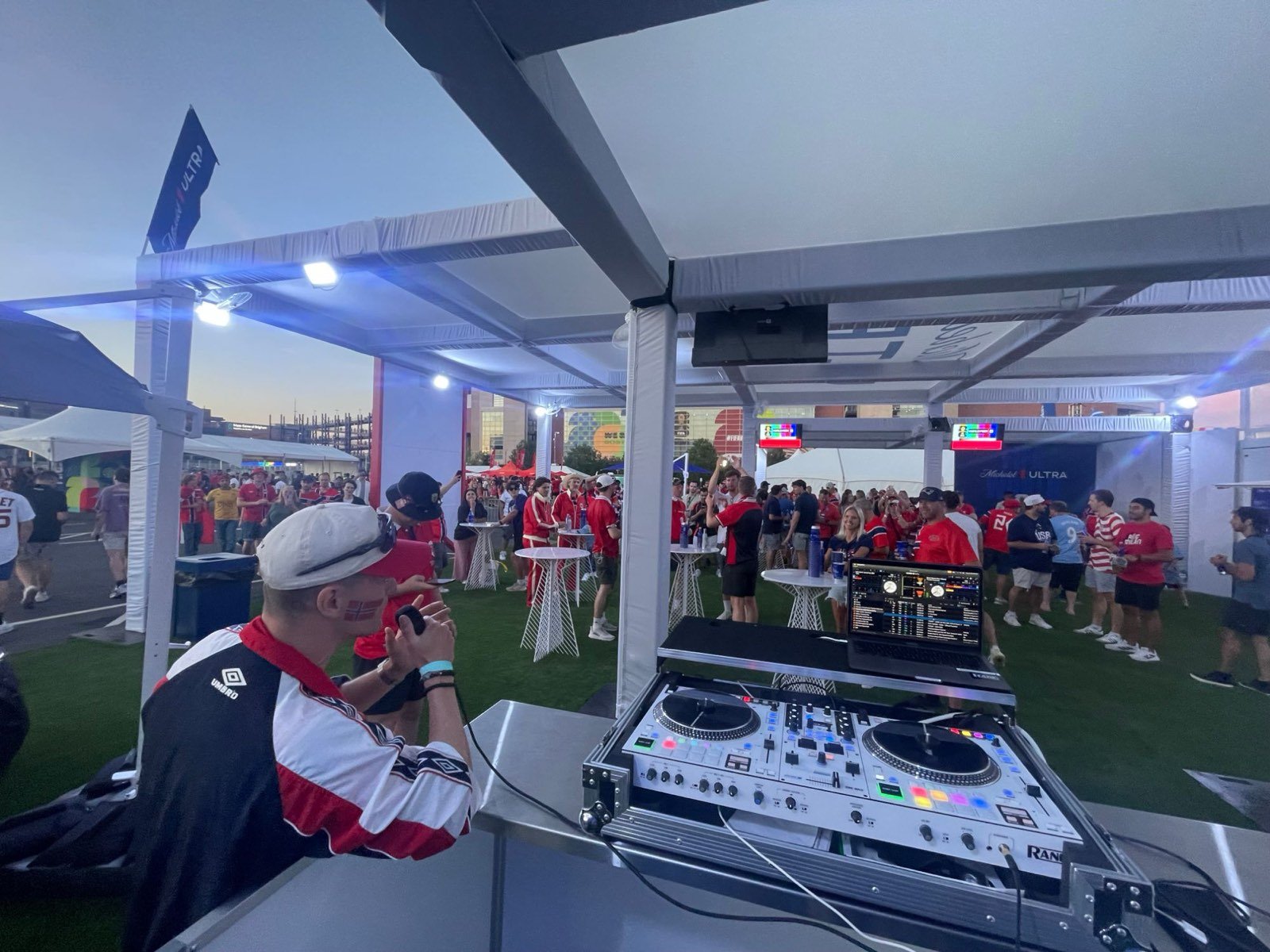 Seacoast DJ booth with a Rane controller at a Michelob Ultra soccer fan zone, with a crowd of fans in team jerseys